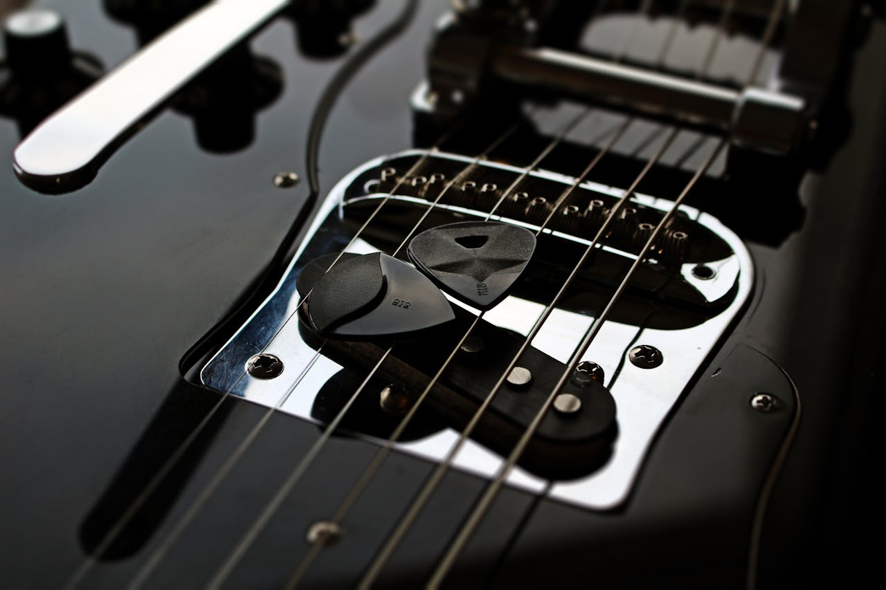 Detailed shot of an electric guitar with picks and strings. Perfect for music and instrument themes.